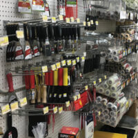 Paint tools and supplies displayed on wall at Wallace Lumber Company
